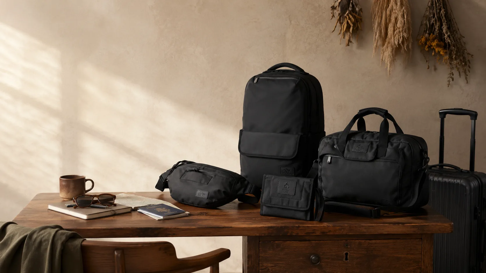 Travel goods laid out on a wooden desk in daylight.